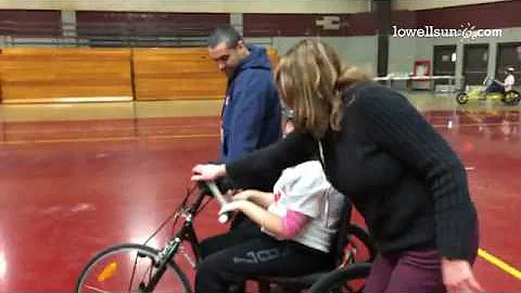 Junior Katherine Solivan riding along on a hand-pu...