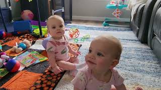 Twins play with baby monitor