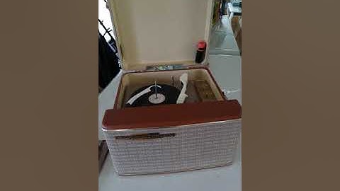RCA 4 speed automatic portable record player, playing a 78 RPM record.
