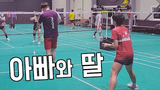 father and daughter playing badminton together