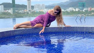 Purple long dress, heels. Wetlook video in the pool.