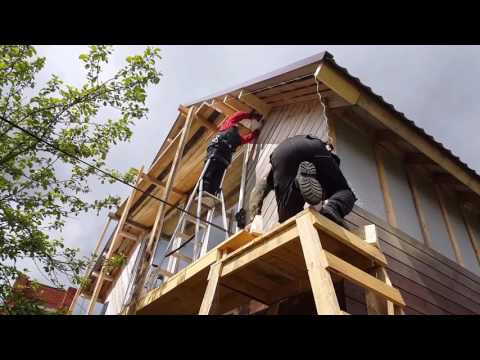 Обшивка дома имитацией бруса.