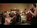 Adorable flower girl performs love is an open door with her mom