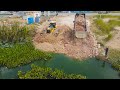 Nice project dump truck transport stone with bulldozer shantui push stone build new road cross water