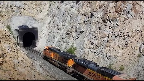 Small gang of railfans watch BNSF freight disappear into Mullan Pass tunnel - 6/25/22