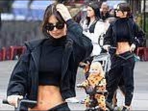 Emily Ratajkowski flaunts her toned abs in a black crop top and matching sweatpants while out