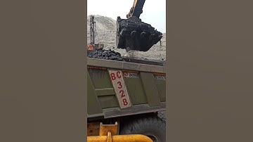 100 tone excavator loading coal cabin to bucket close view. Shovel loading coal cabin close view