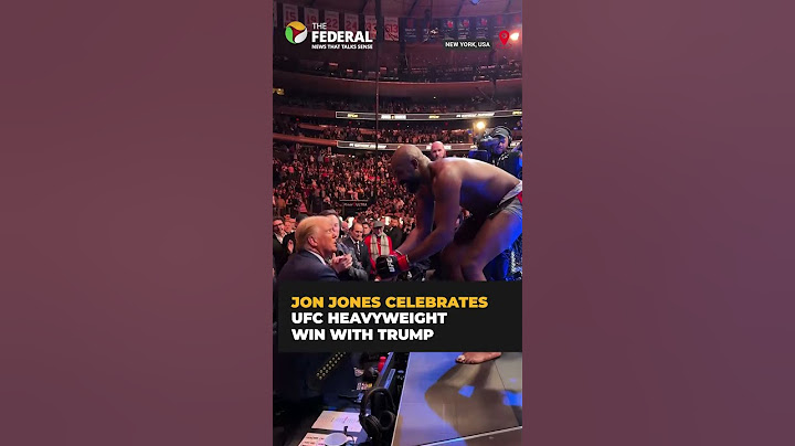 UFC champion Jon Jones hands his heavyweight championship belt to Trump