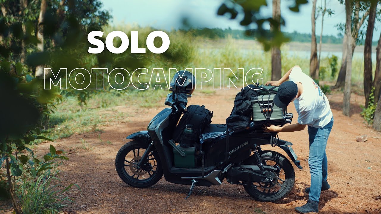Outline Video Camping alone with an electric motorbike by a large lake.