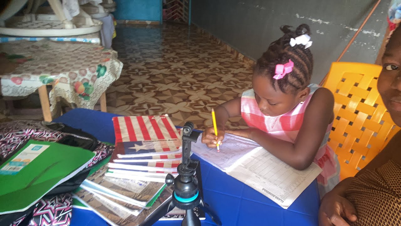 Living in Monrovia Liberia teaching my daughter her lesson on a Sunday