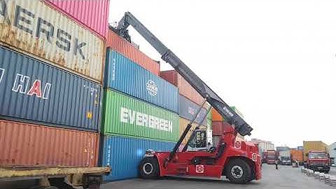 Kalmar Reach stacker with a tilting spreader for container handling.