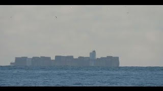 Container ship, bottom part beyond the horizon