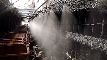 Oasis dust suppression system using fine for nozzle for tracker hopper