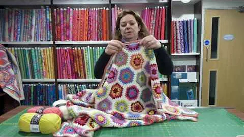 Close-up of a colorful hexagon crochet blanket showcasing vibrant colors and stitches Cozy Hexagon Crochet Blanket