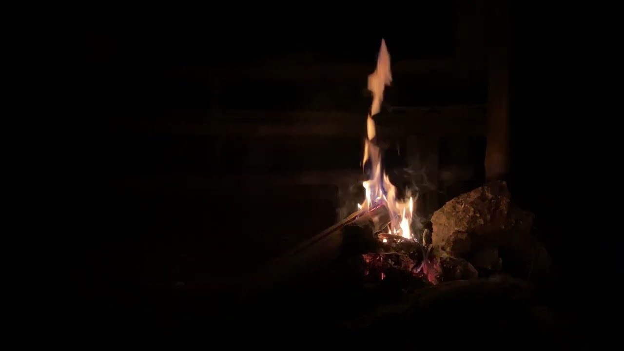 Mesmerizing Allure of a Small Fire at night! Evokes Warmth, Comfort, and a Sense of Cozy Intimacy.