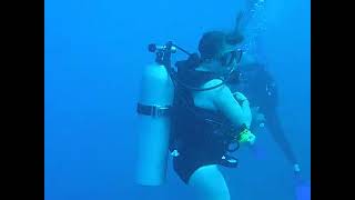 Woman Scuba Diver Ascending To Surface