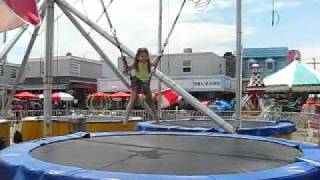 Juliana attached to a bungee cord, jumping on a trampoline.avi