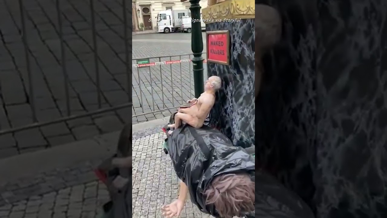 Demonstrators carry statue of naked Putin and Lukashenko to Prague summit