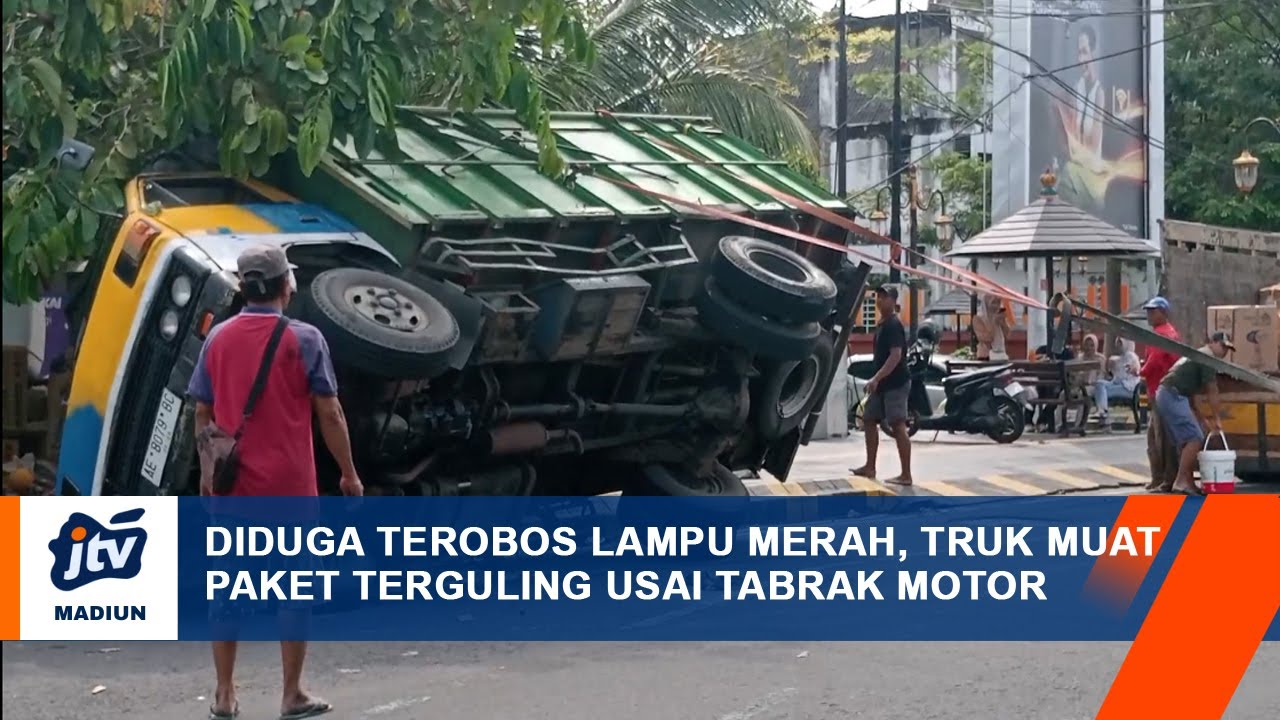 KOTA MADIUN - Diduga Terobos Lampu Merah, Truk Muat Paket Terguling Usai Tabrak Motor