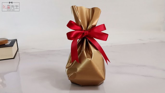 How to Wrap a Present With a Woven Ribbon Gift Topper 