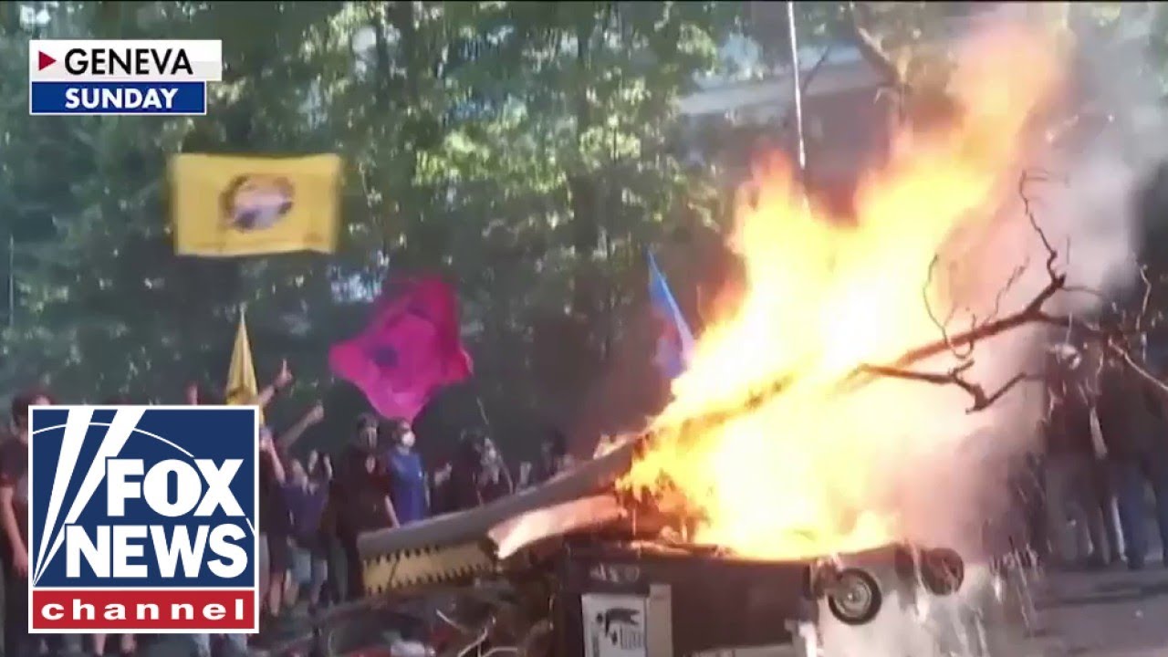 ⁣Security on HIGH ALERT as protests erupt in Geneva ahead of Trump's arrival