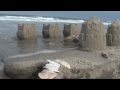 Sand Castle Destruction by Wave
