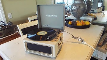 Columbia 4 speed manual record player playing an LP record.