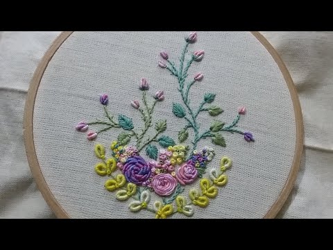 Hand embroidery of a flower pattern with bullion stitch and spider web rose stitch