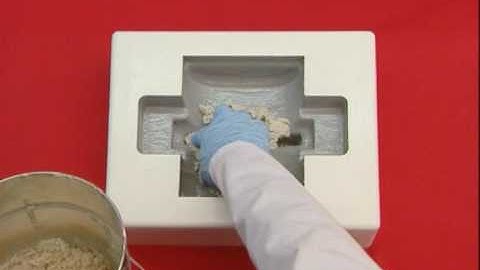 Manufacturing a component using the lay-up method with tamping mixture as a backing structure.