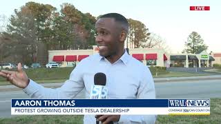 More than 100 people gather outside Raleigh Tesla dealership to protest Musk, DOGE