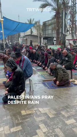 Palestinians in Gaza pray despite rain