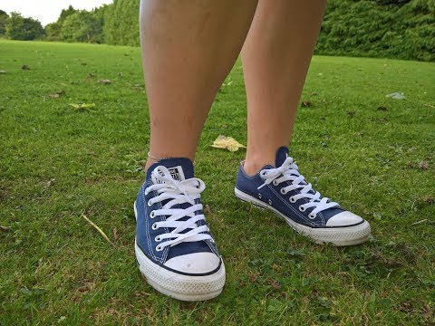 Her sockless converse and feet on grass