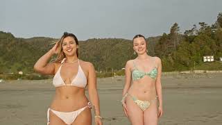 Two Women In Swimwear Walking On Sunny Beach