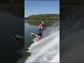Guy is water skiing in the lake without skis!