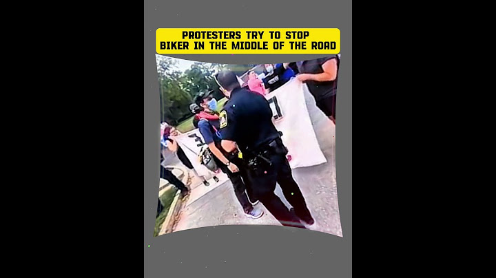 Protesters Try to Stop Biker in the Middle of the Road