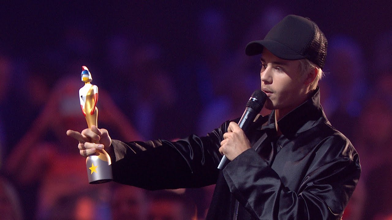 Justin Bieber receiving Grammy Award