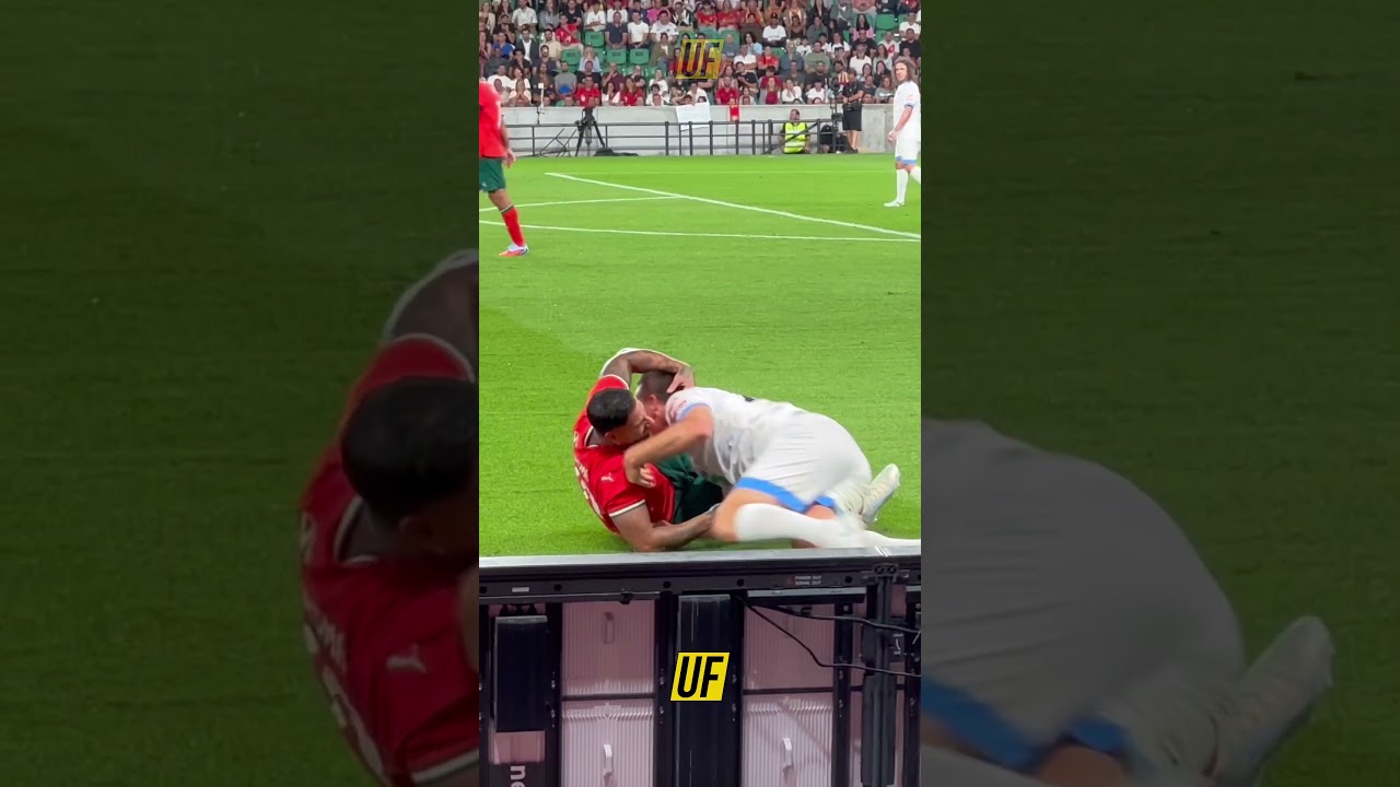 Quaresma and Terry hugging laying on the pitch. Legends Charity Game