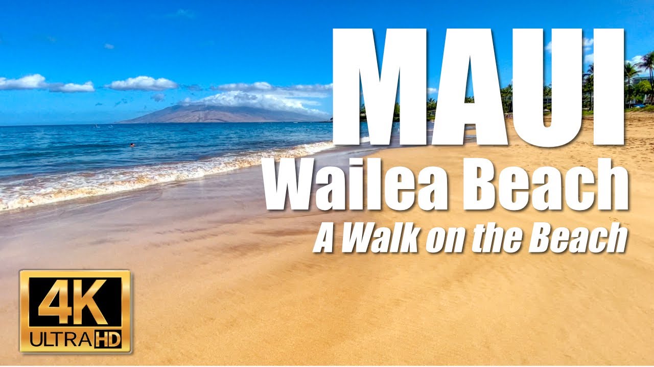 Walking through the ocean surf rolling to shore at Wailea Beach Walk in Wailea, Maui, Hawaii    4K