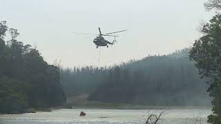 Rescue Helicopter Taking water to Stop fire in forestdale forest