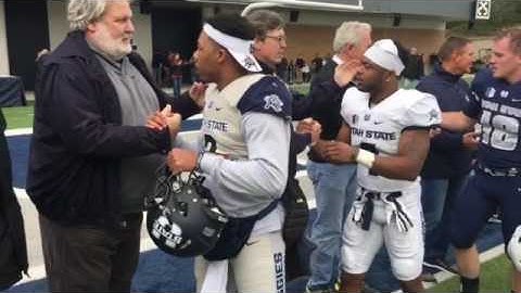 Football players greet former Aggies following the spring game.
