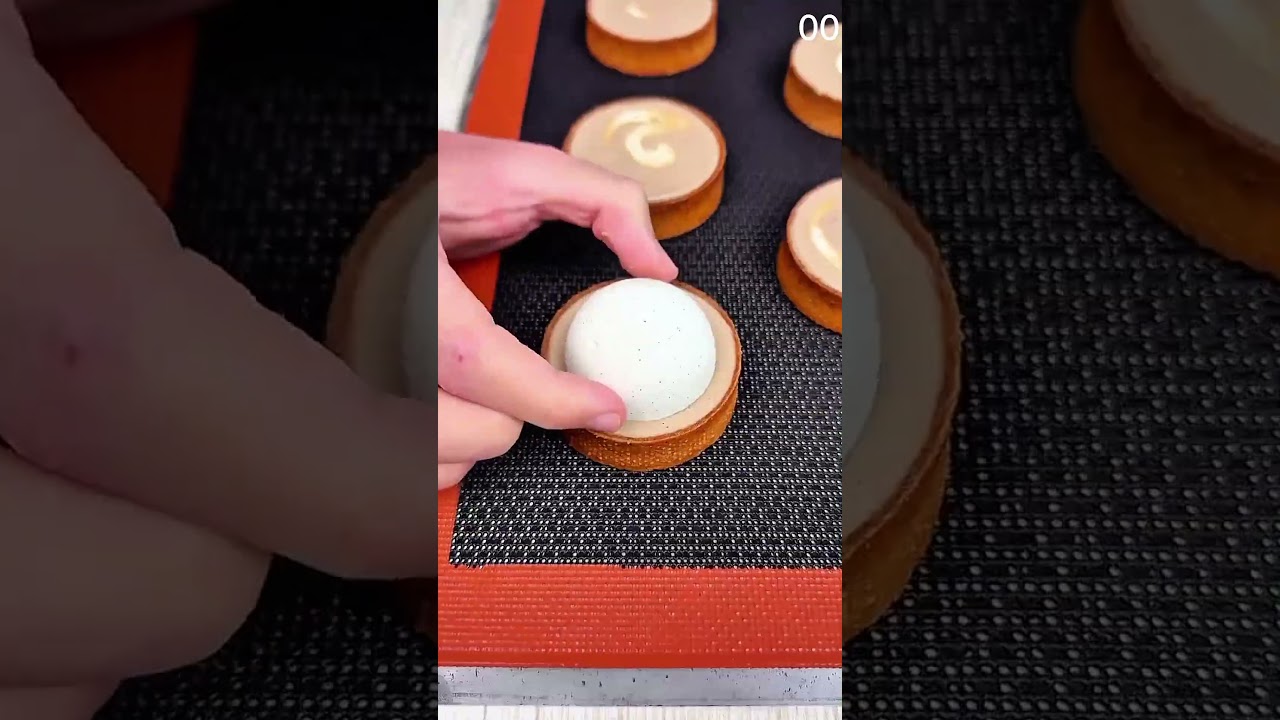 Golden pastry swirls rise, crowned with delicate gold leaf.