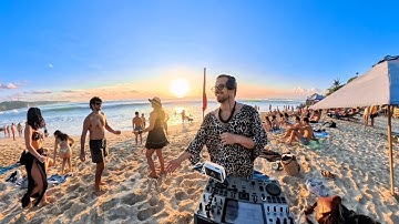 Playing afro house music on the beach until people dance