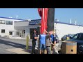 Lowering and replacing the American flag at Glenbrook Dodge on Coliseum