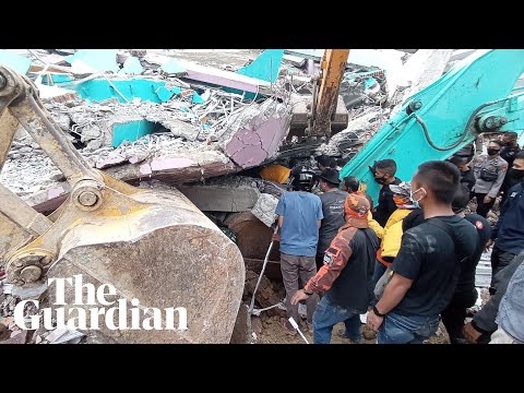 Indonesia earthquake: rescue workers search rubble with dozens reported dead