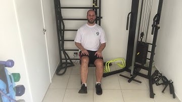 Extensão do joelho unilateral sentado na cadeira