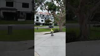 Girl on inline skates rides downhill then falls forward and faceplants on to curb