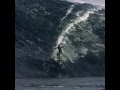 A huge wave and surfers