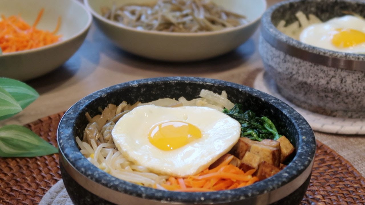 Vegetarian dolsot (stone pot) bibimbap with gochujang peanut sauce