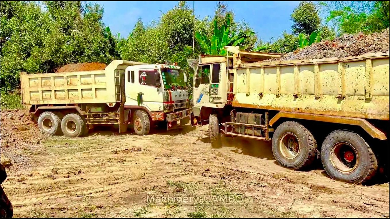 Only two earthmoving trucks are working today because the work area is cramped