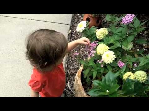 Ava smelling flowers